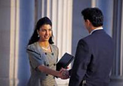 Photo of woman shaking hands with man
