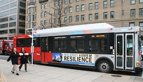 photo of NJ city bus displaying the ad New Jersey A State of Resilience