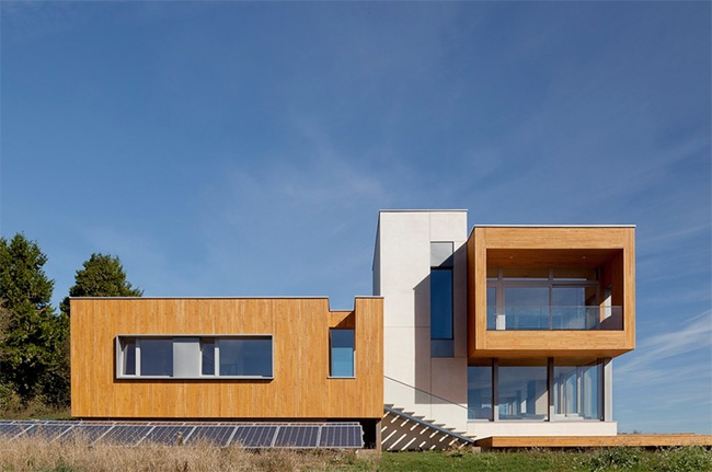 exterior of the Karuna House, Portland Oregon, showing the strength of the geometry and the PV array in the foreground